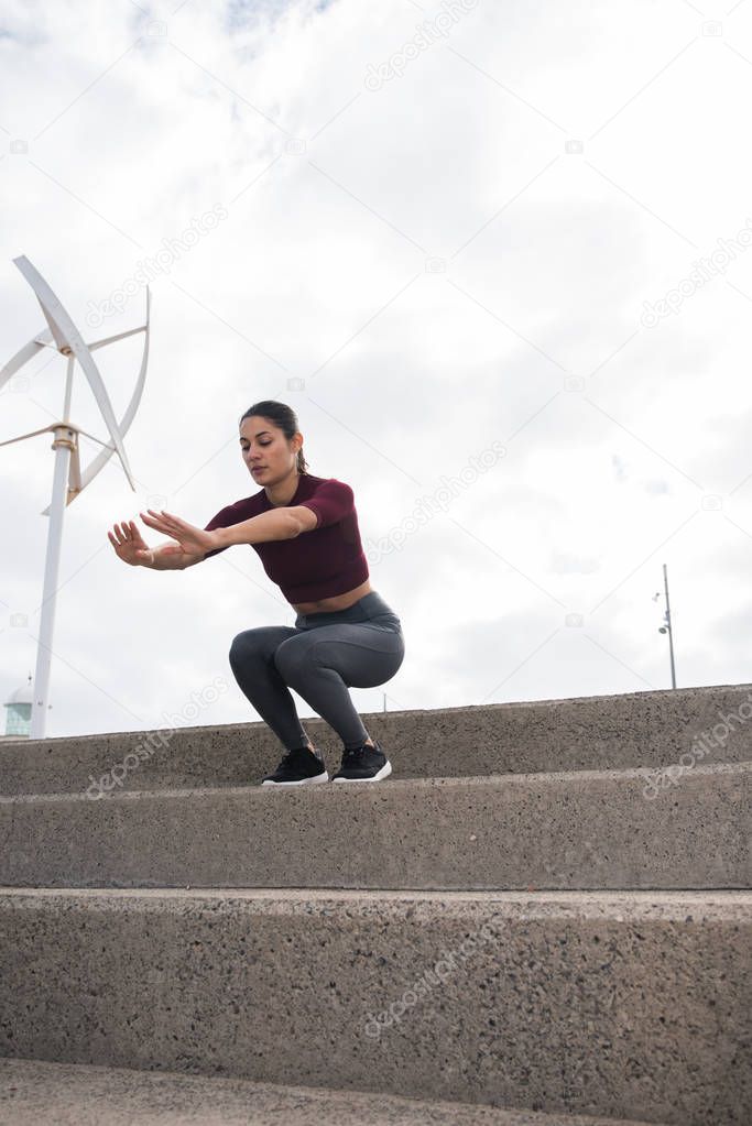 young woman exercising on stairs