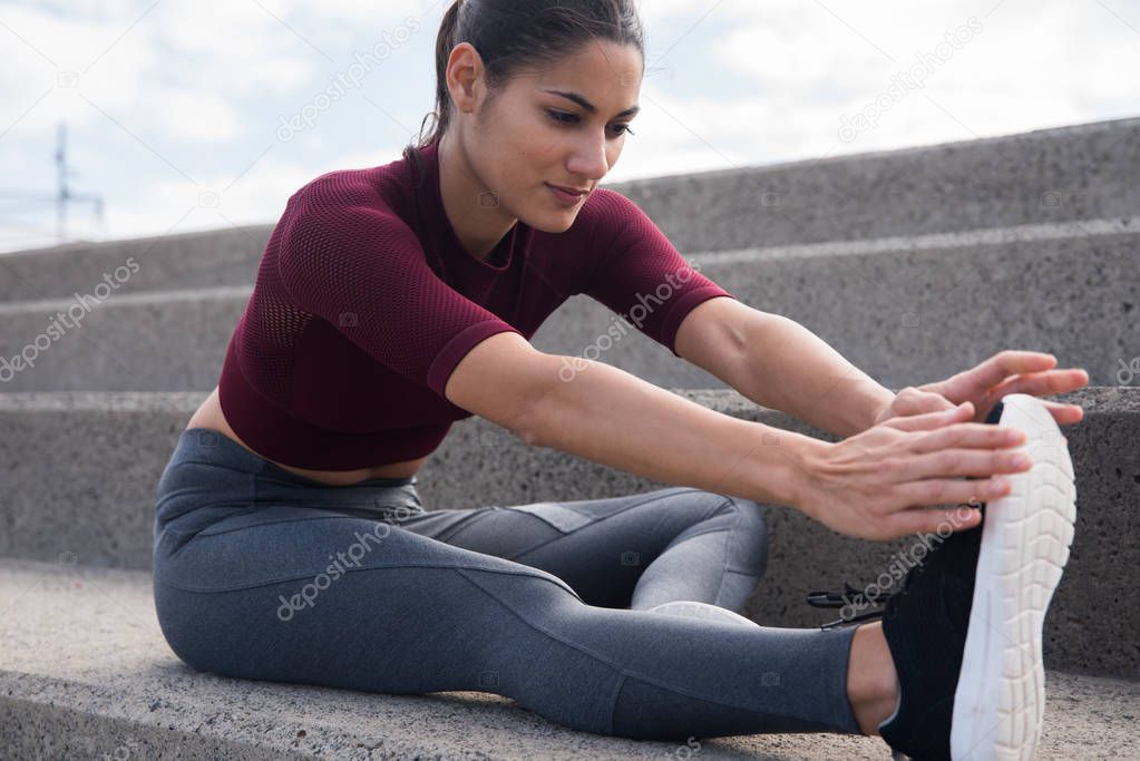 Pretty young woman doing stretches
