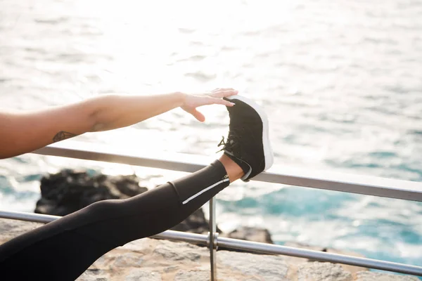 Lady in tights touching toes — Stock Photo, Image