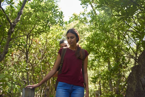 Young lady looks down as she negotiates a path