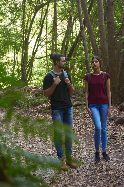 Young couple strolling in the forest