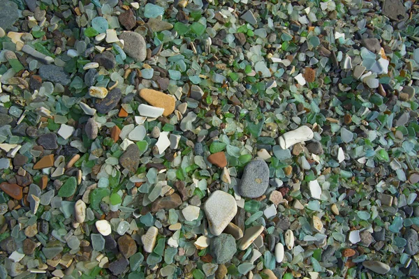 Seashore in stones and smooth glass — Stock Photo, Image