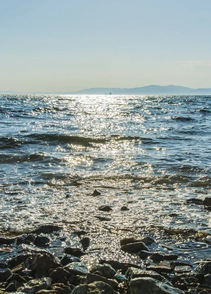 El sol se pone al mar, las olas en la costa en parches soleados —  Fotos de Stock