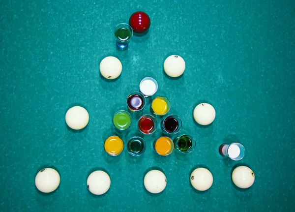 Num suporte de mesa de bilhar com copos coloridos de álcool . — Fotografia de Stock