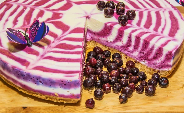 beautiful bright cake with currants, white with purple cake adorned with berries,