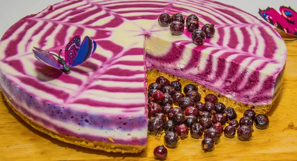 beautiful bright cake with currants, white with purple cake adorned with berries,