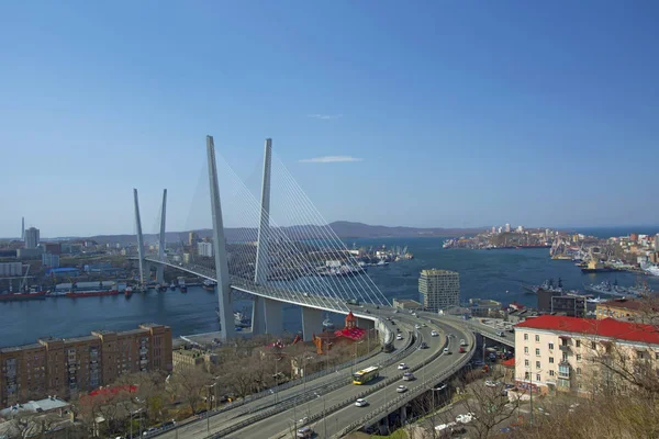 El puente sobre la bahía, en la ciudad portuaria. día soleado y floreciente vegetación —  Fotos de Stock