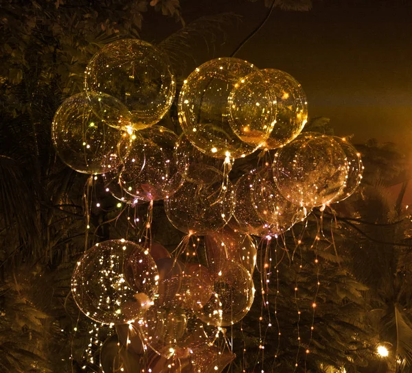 big beautiful gel balloons, painted lights and light bulbs. at night. Asia