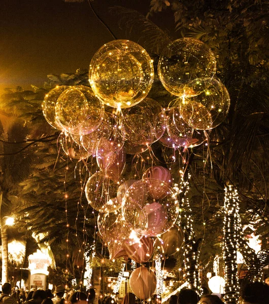 big beautiful gel balloons, painted lights and light bulbs. at night