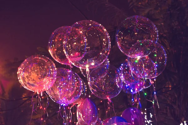 big beautiful gel balloons, painted lights and light bulbs. at night