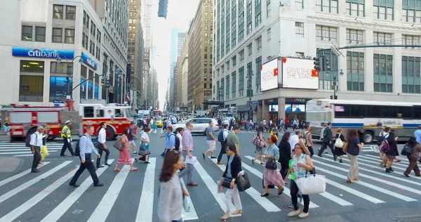 Manhattan crosswalk wide high angle overhead view during rush hour commute. FDNY fire truck passes street intersection. — Stock Photo, Image