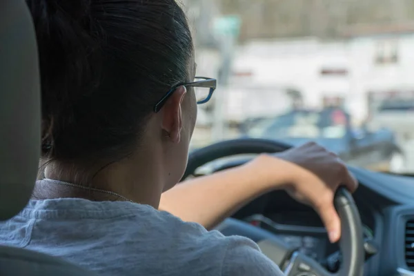 波夫年轻女子在繁忙的城市街道上开车 — 图库照片