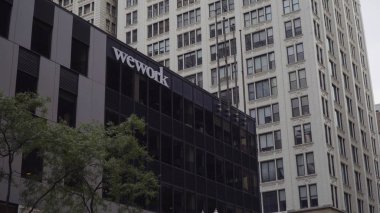 Chicago, USA - Circa 2019: Wework american real estate company provide shared work space for technology start up businesses clipart