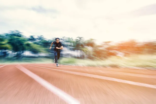Running Man running on the track with radial blur, Sport and Act