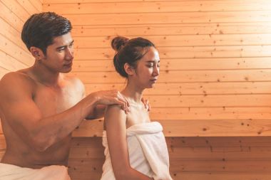 Young Asian couples or lovers have romantic relaxing in sauna ro clipart