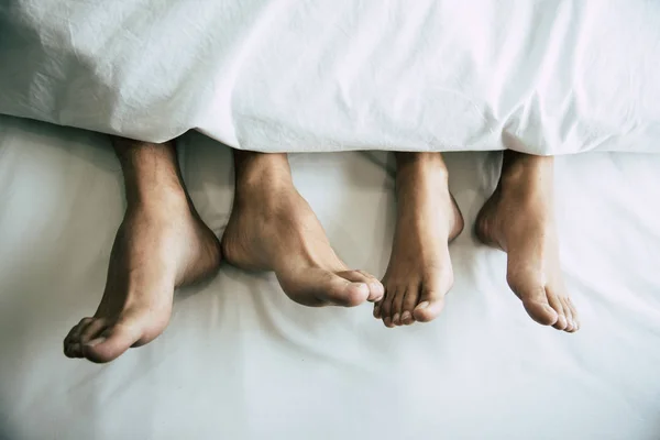 Barefoot of lovers under blanket in bedroom. Vacation and Happiness of sexual. Valentines day theme. — Stock Photo, Image