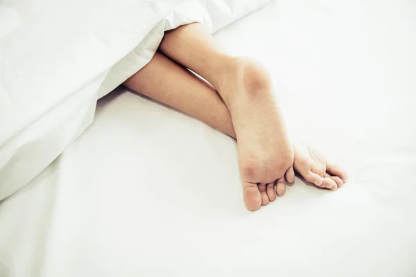 Barefoot of human on bed in morning. Single and Working people concept. Lazy day and Happiness home theme. — Stock Photo, Image