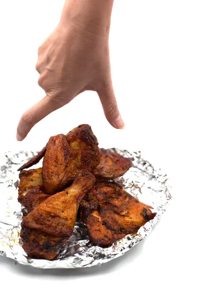 手抓烤翅。美味的烧烤鸡肉箔上孤立的白色背景。食品和开胃概念 — 图库照片