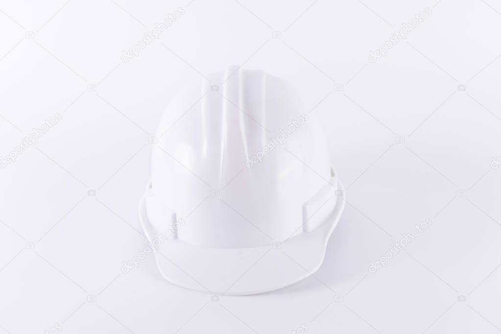 White safety helmet on white background. Hard hat and thick gloves on white isolated background. Safety equipment concept. Worker and Industrial theme.