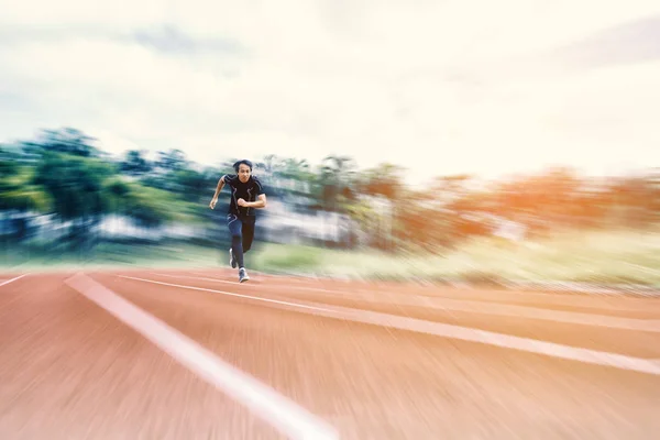 Running Man running on the track with radial blur, Sport and Activity concept