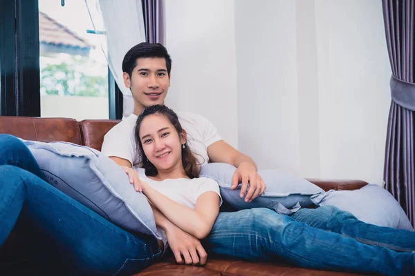 Asya Genç çiftler kanepede rahatlatıcı. Severler ve çiftler kavramı. Balayı ve düğün Tema. İç ve Dating Tema. — Stok fotoğraf