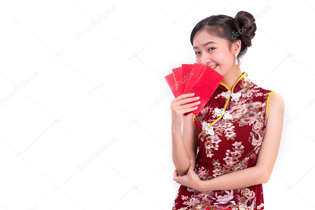 Young Asian beauty woman wearing cheongsam and holding packet of moneys gesture in Chinese new year festival event on isolated white background. Holiday and Lifestyle concept. Qipao dress wearing
