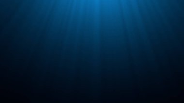 Derin mavi denizaltı. Güneş ışığı yüzeydeki dalgalanmaları aydınlatıyor.