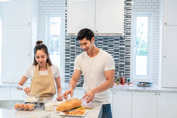 Feliz asiática parejas cocinar y hornear pastel juntos en cocina — Foto de Stock