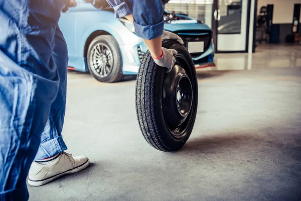 Mécanique automobile changement de pneu à l'atelier de réparation automobile garage. Transpor — Photo