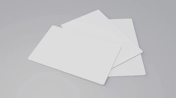 Біла подарункова картка макет кредитної картки, що укладається на сірий стіл — стокове фото