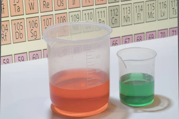 Sostanze chimiche in forma liquida a fini didattici con la tavola periodica  . — Foto Stock