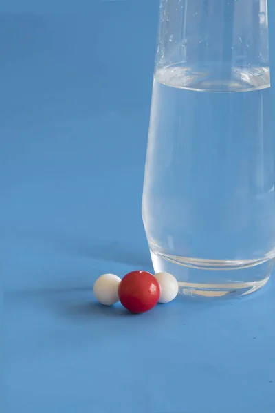 Water illustrated with a hydrogen and oxygen atom .