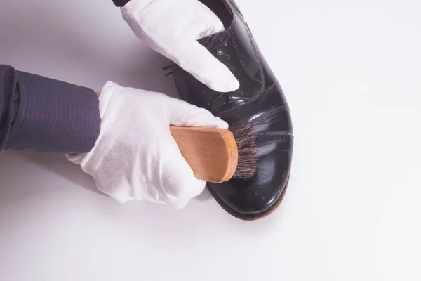 Person working on cleaning and shining shoes for formal and fashion wear