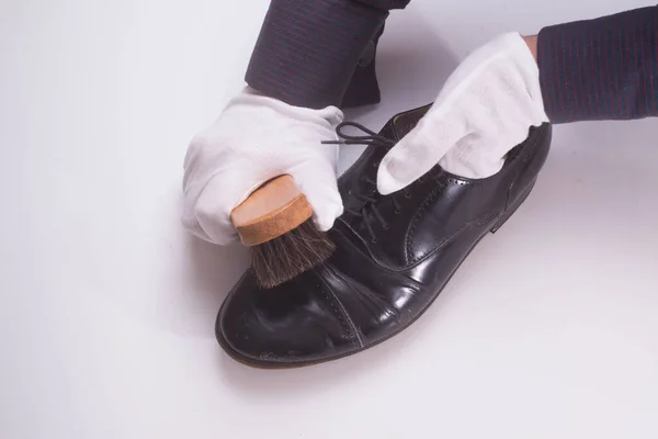 Person working on cleaning and shining shoes for formal and fashion wear