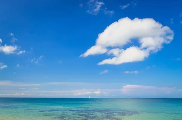 Paisaje oceánico con cielo azul nublado y velero — Foto de Stock