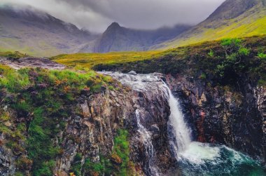 Gorgeous landscape view of Cuillin hills with river stream and waterfall, Scotland clipart