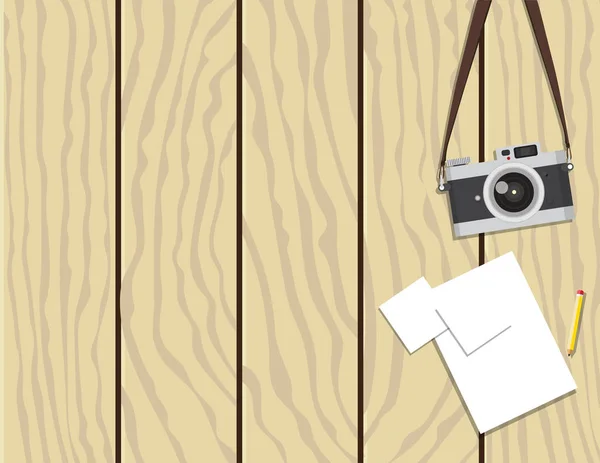 Κάμερας ρετρό και χαρτιού σε ξύλινο φόντο — Διανυσματικό Αρχείο