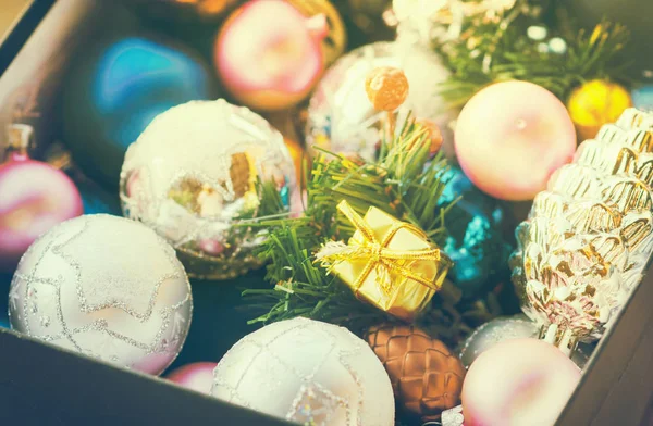 Flerfargede leketøy til jul, teksturerte baller ligger i en åpen eske, virkningen av instagrammet – stockfoto