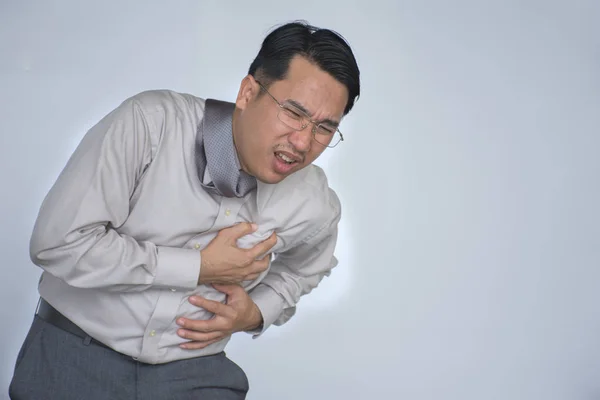 Чоловік має біль у грудях - серцевий напад/молодий атлетичний чоловік має раптовий серцевий напад/Чоловік має сильний біль у грудях, як серцевий напад та концепція захворювання ізольовані на білому тлі — стокове фото