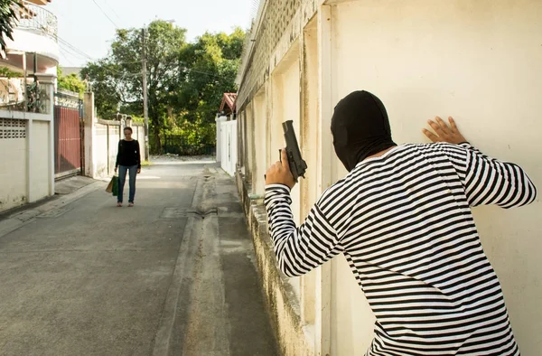 被害者を見て 最寄りの貴重品 犯罪概念を盗むためにくるを待って 壁の後ろに立って銃を持つ強盗泥棒刑事 — ストック写真