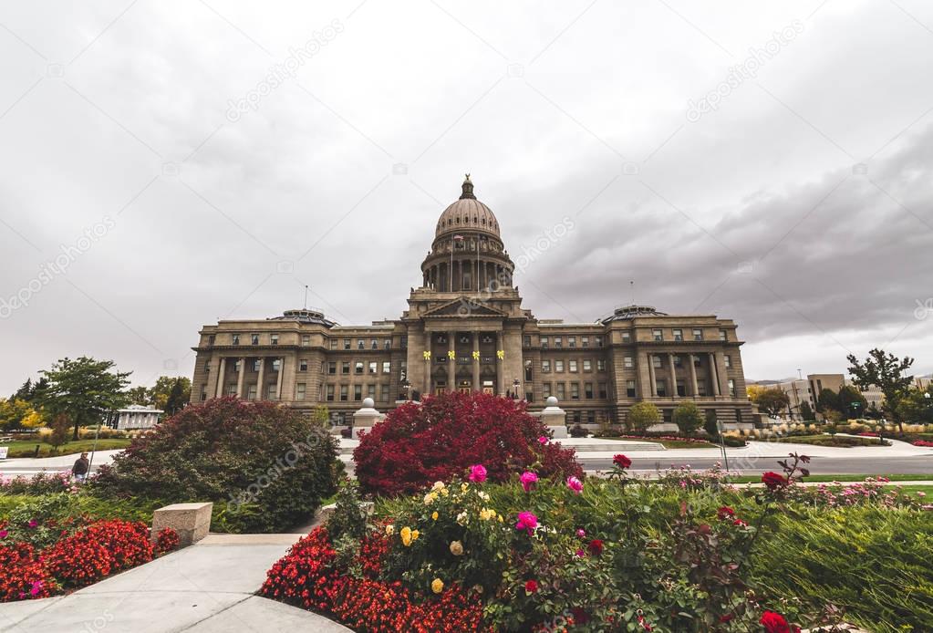 Idaho State Capitol Building with bright flowers and cloudy sky