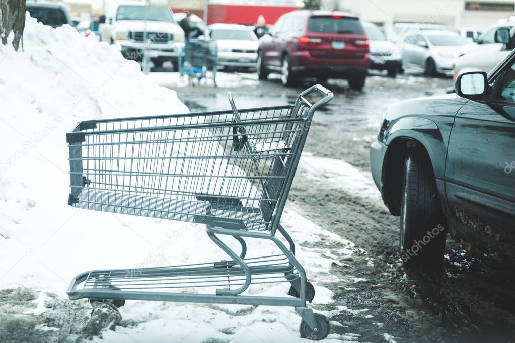 Shopping Cart in Snowy Parking Lot