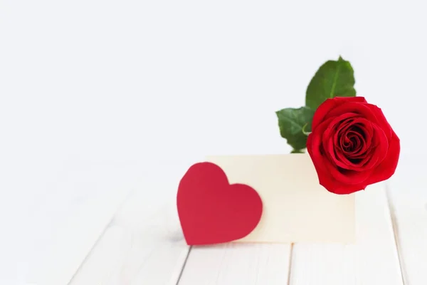 Rose, hearts and card on table Stock Photo