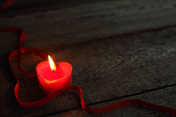 Heart shaped candle burning — Stock Photo, Image