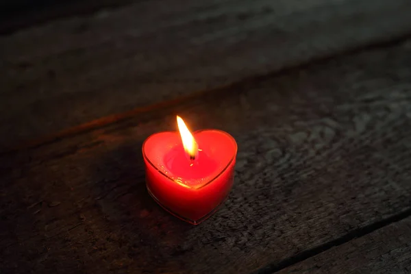 Heart shaped candle burning — Stock Photo, Image