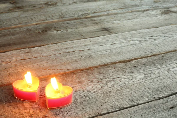 Heart shaped candles burning — Stock Photo, Image