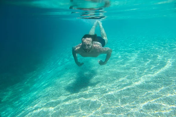 Человек плавает под водой — стоковое фото