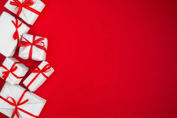 Many holiday gifts on red — Stock Photo, Image