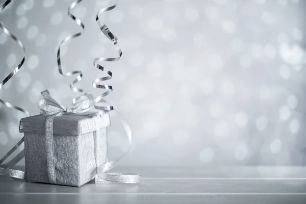 Silver Christmas gift with ribbon — Stock Photo, Image