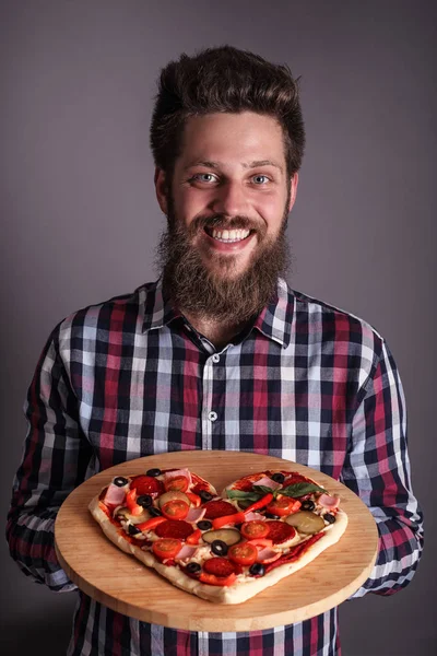 Man holding heart pizza — Stock Photo, Image